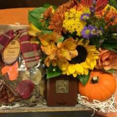 A bouquet of flowers and other items are on the table.