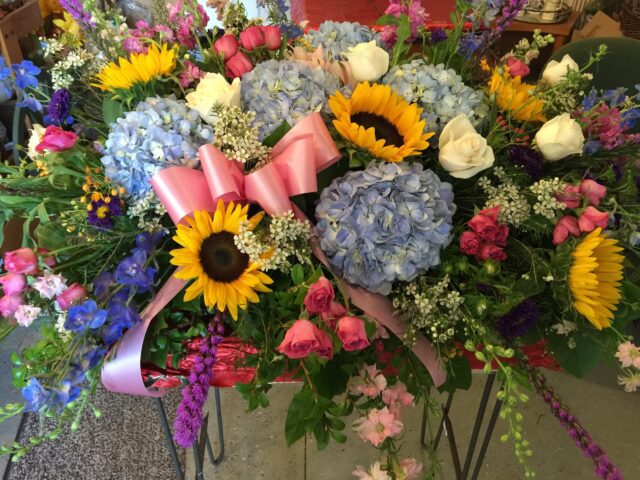 A bouquet of flowers with sunflowers and other flowers.