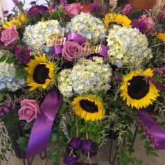 A bouquet of flowers with sunflowers and roses.