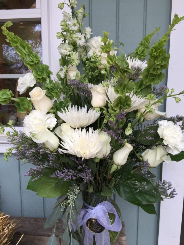 A bouquet of flowers in front of a door.