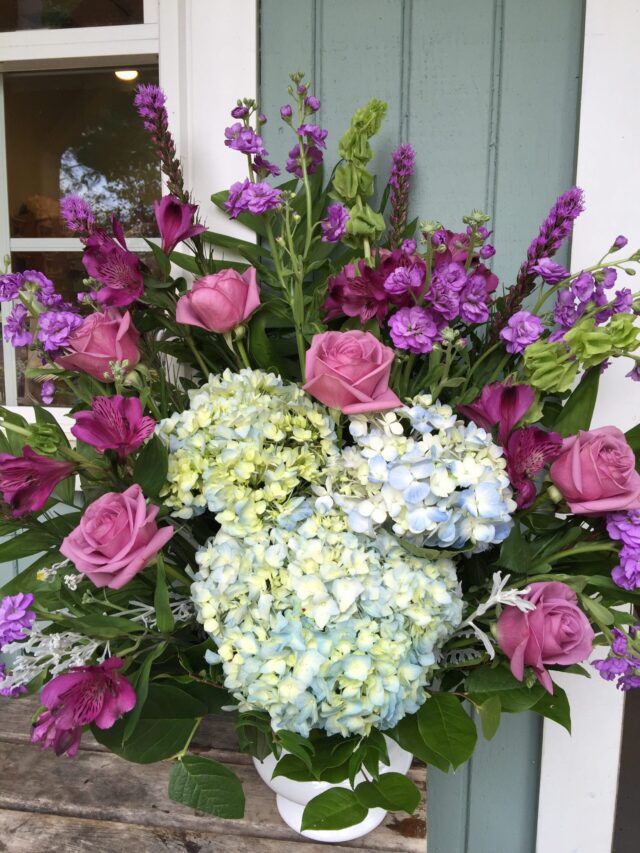 A bouquet of flowers is sitting on the door.