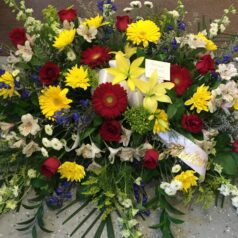 casket piece yellow red white flowers