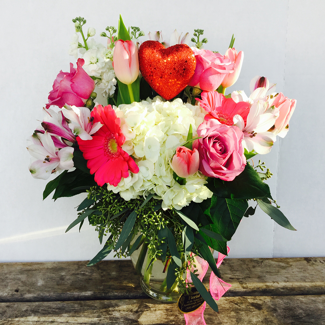 A White and Pink Flower Arrangement With a Heart
