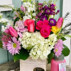 A bouquet of flowers in a wooden box.