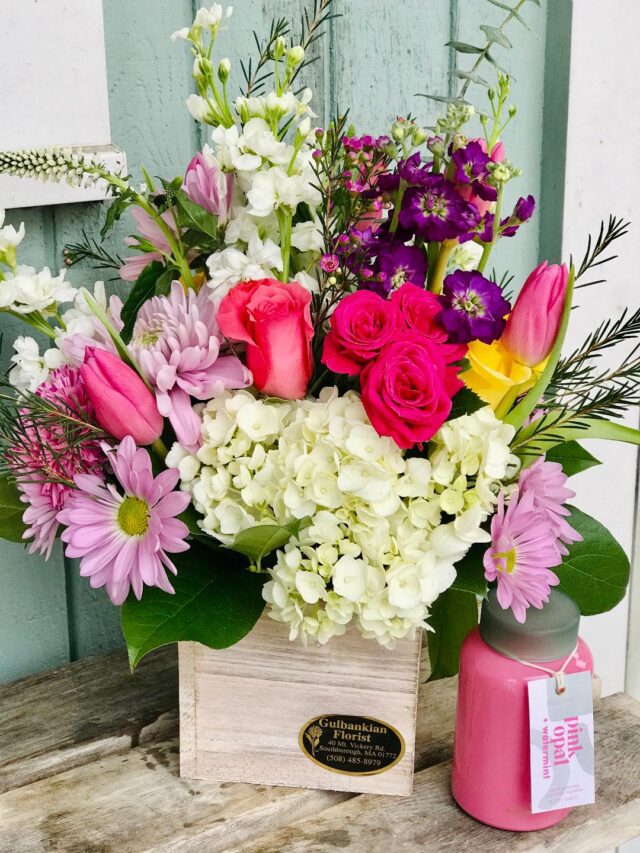 A bouquet of flowers in a wooden box.