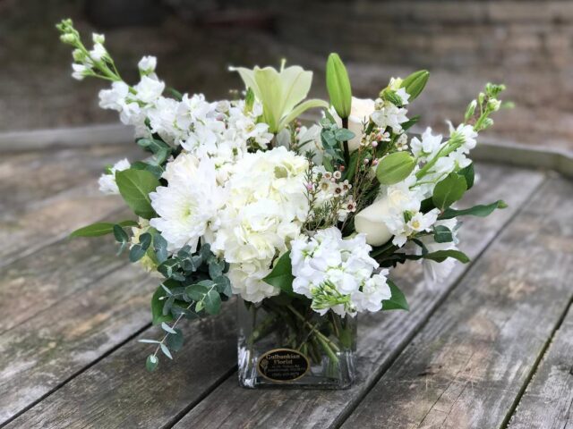 A bouquet of flowers in a glass vase.