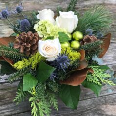 A bouquet of flowers sitting on top of a wooden table.