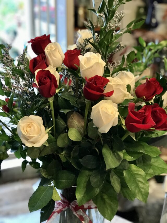 Red and White Color Roses in a Glass Vase