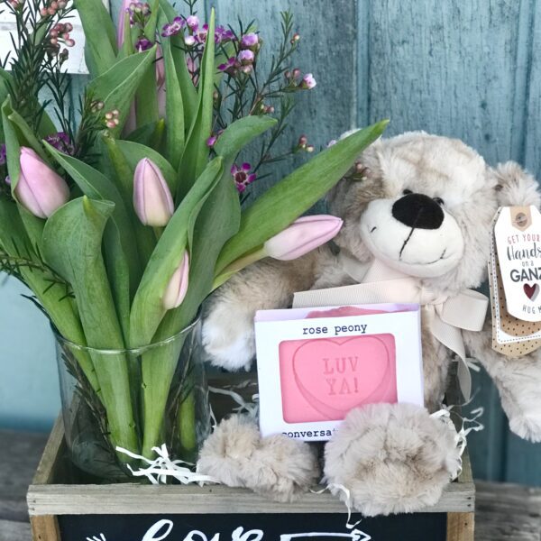 A Teddy bear With a Vase of Pink Tulips