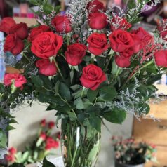 A Bunch of Two Dozen Red Roses in a Glass Vase