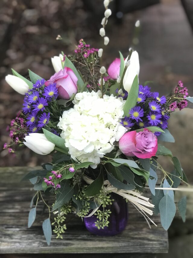 A bouquet of flowers in a vase on the table.