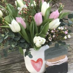 A vase with flowers in it on top of a table.