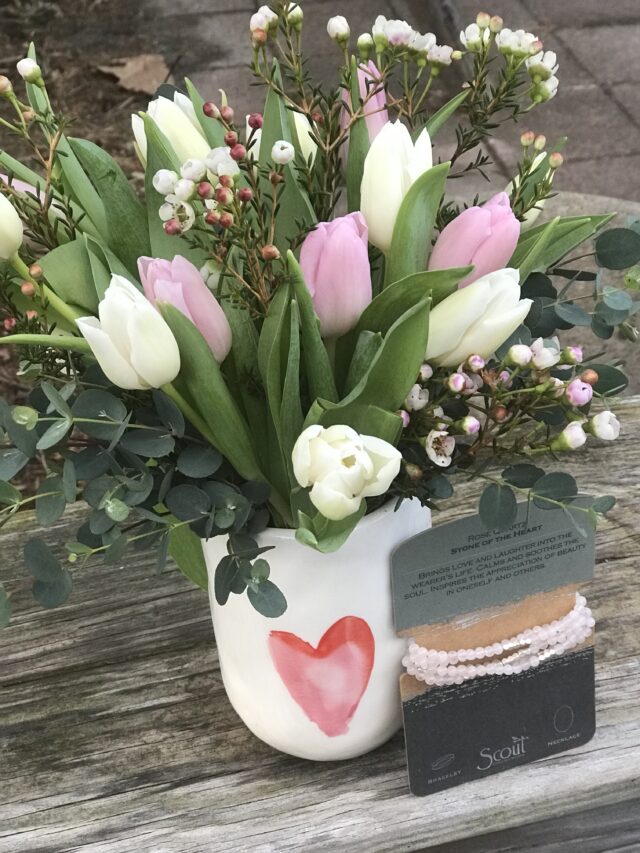 A vase with flowers in it on top of a table.