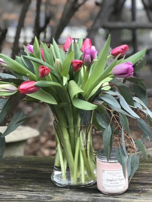 A vase filled with pink flowers on top of a table.