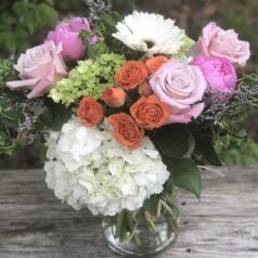 A vase filled with flowers on top of a wooden table.