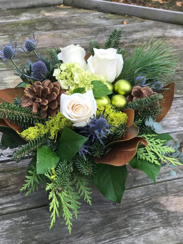 A bouquet of flowers sitting on top of a wooden table.