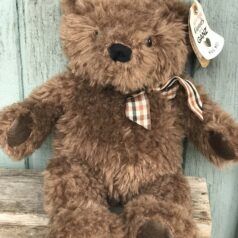 A brown teddy bear with a bow tie.