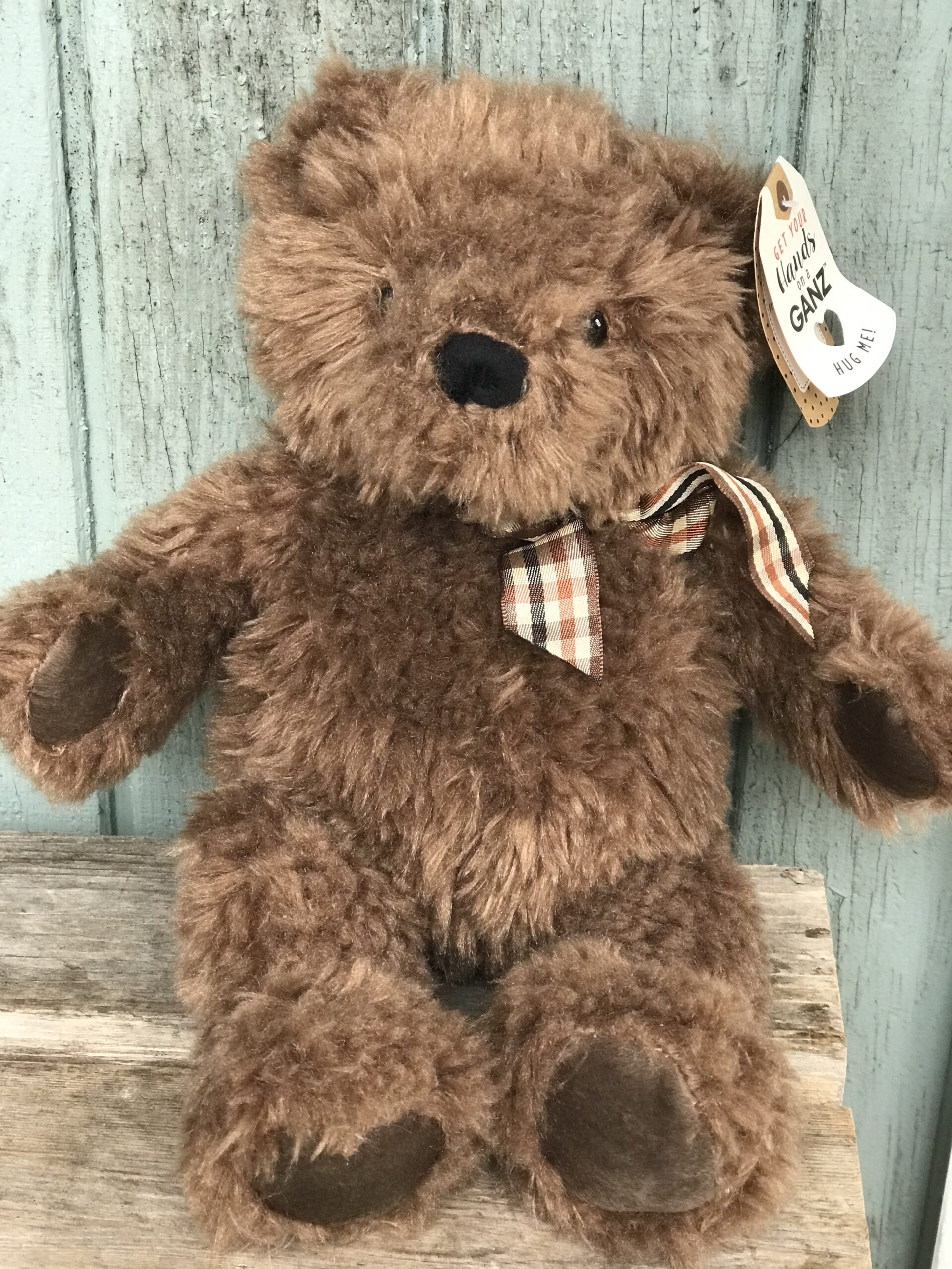 A brown teddy bear with a bow tie.