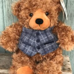 A teddy bear wearing a vest and tie.