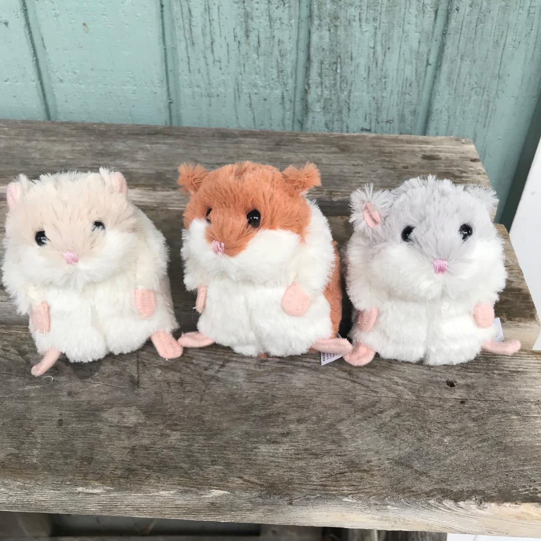 Three stuffed animals are sitting on a table.