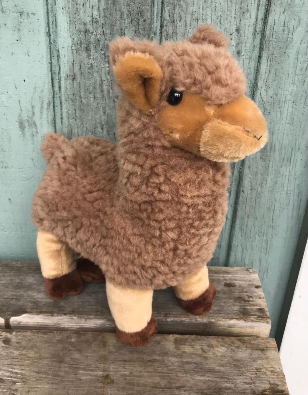 A stuffed animal is sitting on top of some wood.