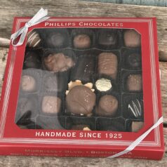 A box of chocolates sitting on top of a table.