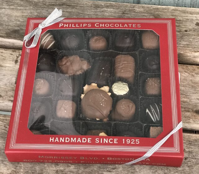 A box of chocolates sitting on top of a table.