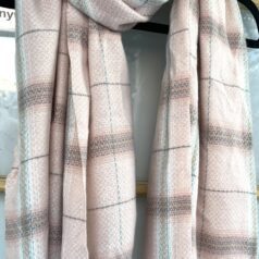 Pink plaid scarf with tassels.