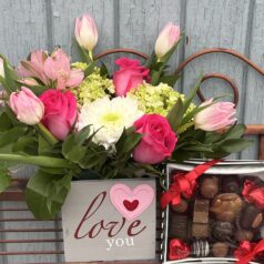 Flowers, chocolates, and "Love you" sign.