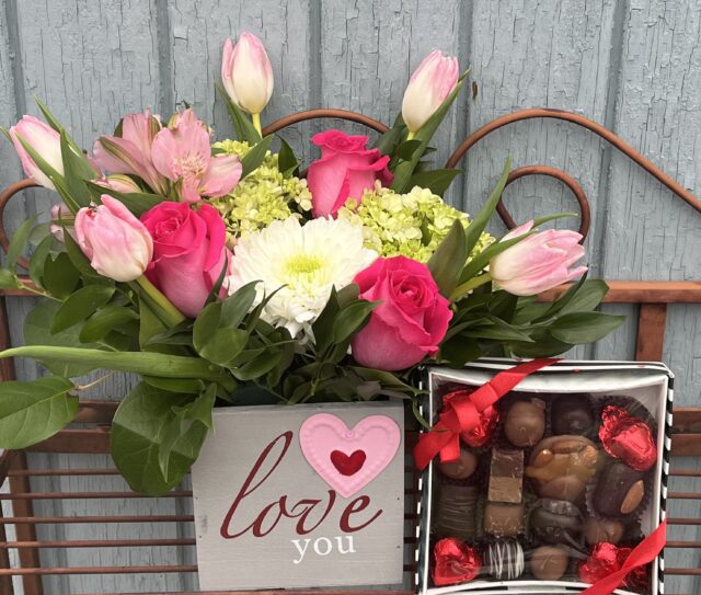 Flowers, chocolates, and "Love you" sign.