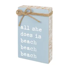 Decorative sign with beach-themed text.