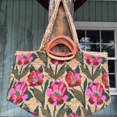 Colorful pink jute tote bag with wooden handles and shoulder straps
